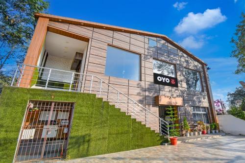 a house with a staircase in front of it at Hotel O THE WEDDING RINGS in Dhanbād
