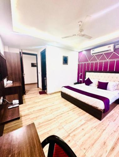 a bedroom with a large bed with a purple headboard at Gupta guest house in Dehradun