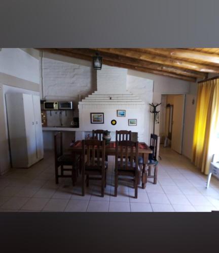 ein Esszimmer mit einem Tisch und Stühlen sowie eine Küche in der Unterkunft Vistalba Country in Ciudad Lujan de Cuyo