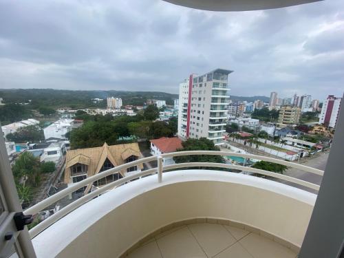 a balcony with a view of a city at Departamento frente al mar in Tonsupa
