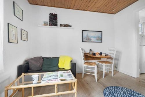 a living room with a couch and a table at 5644-Gudhjem-Holkavej-13-B in Gudhjem