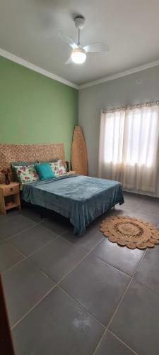 a bedroom with a bed in a room with a window at Casa de praia Lar abençoado! in Cabo Frio