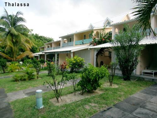 a house with trees in front of it at 11 residence thalassa in Belle Mare