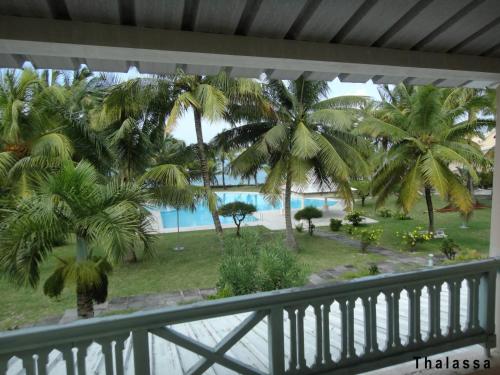 a view from the balcony of a resort with palm trees at 11 residence thalassa in Belle Mare