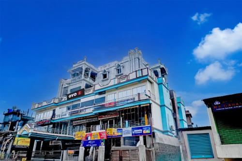 a tall white building with balconies on top of it at Hotel O The Silver Stone in Guwahati