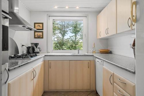 a kitchen with a sink and a window at LF11115-Struer-Gl-Landevej-14 in Struer