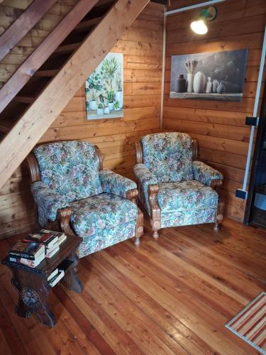 two chairs and a coffee table in a attic at Chalet Aledia in Pessinetto