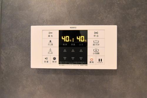a digital clock on top of a wall at MARIO House - Free Parking- in Osaka
