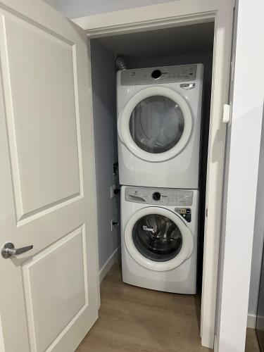 a washer and dryer in a small room at Peaceful Haven in Prime Location in Calgary