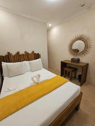 a bedroom with a large bed with a mirror on the wall at Pook ni Urduja Resort 