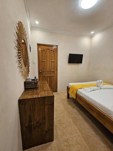 a bedroom with a bed and a mirror on the wall at Pook ni Urduja Resort 