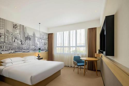 a hotel room with a bed and a tv at City Comfort Inn Shiyan Wudang Mountain in Danjiangkou