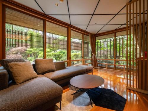 a living room with two couches and a table at Haiya in Awara