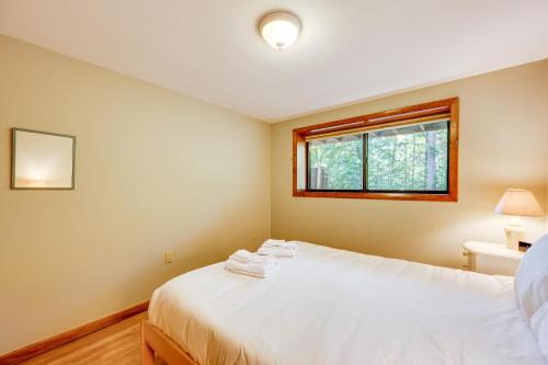 a bedroom with a white bed and a window at Near Skiing and Hiking! North Conway Gem with Balcony in Intervale