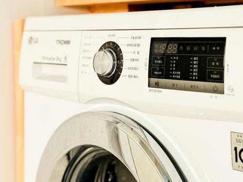 a white washing machine with its door open at Sum Leisure Gocheok Dome 6 minutes Emotional 4-person two-room in Seoul