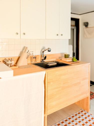 a kitchen with white cabinets and a sink at Sum Leisure Gocheok Dome 6 minutes Emotional 4-person two-room in Seoul
