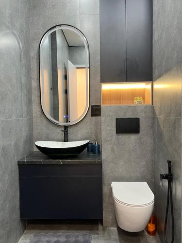 a bathroom with a sink and a mirror at Апартаменты в центре Астаны in Astana