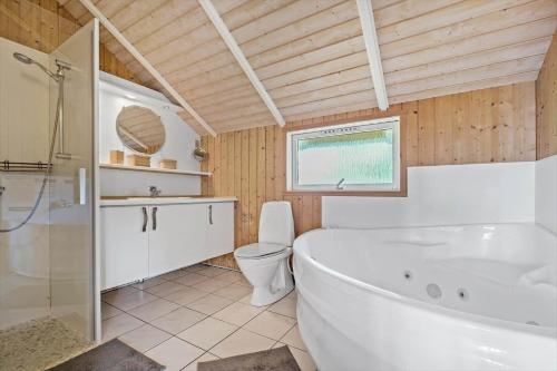 a bathroom with a tub and a toilet and a sink at SB56207-Sydals-Solbjergvej-26 in Sønderby