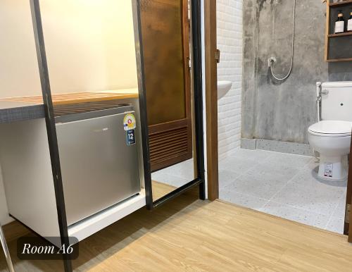 a bathroom with a shower and a toilet at Friend Nest Bangkok in Bangkok