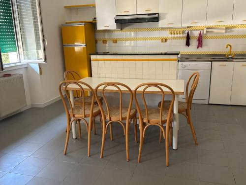 a kitchen with a table and four chairs at Tower casa vacanze in Anzio