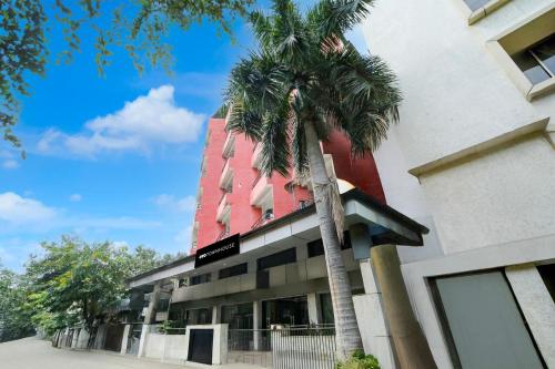 a palm tree in front of a building at Townhouse Hotel Bhopal Station Inn in Bhopal