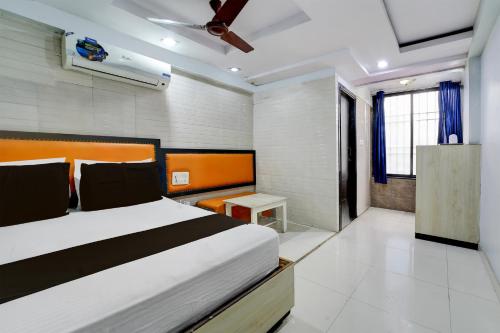 a bedroom with a large bed and a table at Townhouse Hotel Bhopal Station Inn in Bhopal