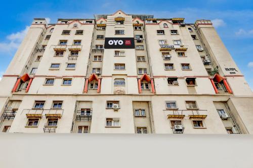a large white building with an opera sign on it at Hotel O Kalyan in Ahmedabad