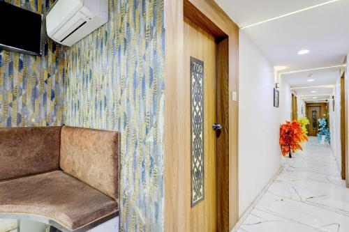 a hallway with a door and a wall with a blue and white wallpaper at Hotel O Kalyan in Ahmedabad
