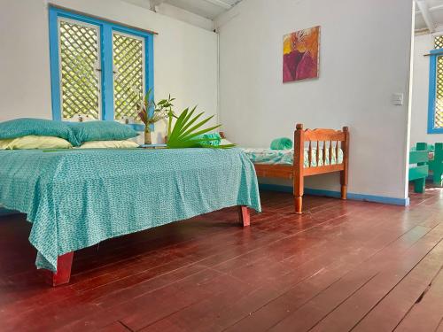 a bedroom with a bed and a bench in a room at Villas Itaita Beach Cabins in Punta Uva