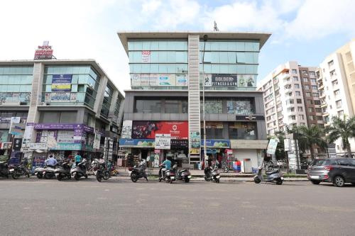a group of motorcycles parked in front of a building at Hotel O Shyam Vatika Banquet And Rooms in Surat