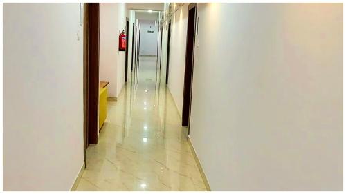 a hallway of an office building with a long corridor at Premium Facilities Hotel R A T R E E - Comfortable and Serene Stay in Bhopal