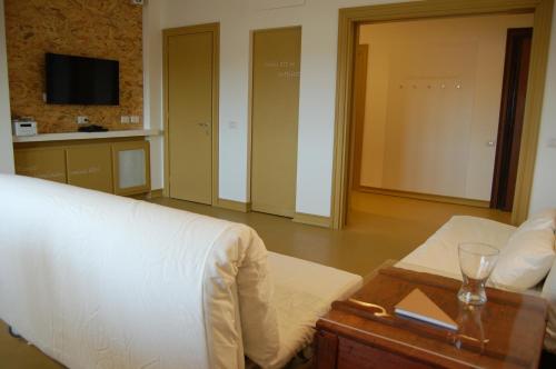 Cette chambre comprend un lit et une table avec un verre de vin. dans l'établissement Casa accanto al Vaticano, à Rome