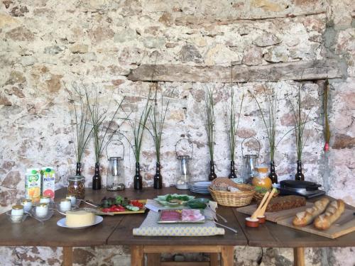 
a table topped with pots and pans filled with food at Domaine De Brousson in La Tour-sur-Orb
