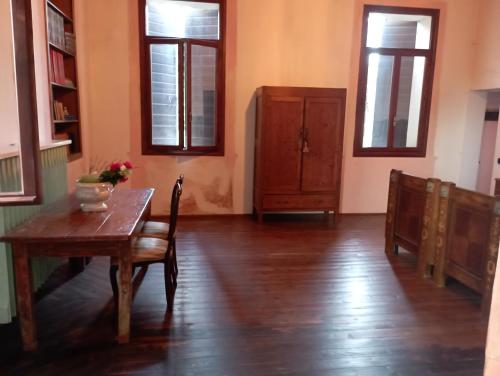 a dining room with a table and a wooden floor at LA GASTALDIA in Pontecasale