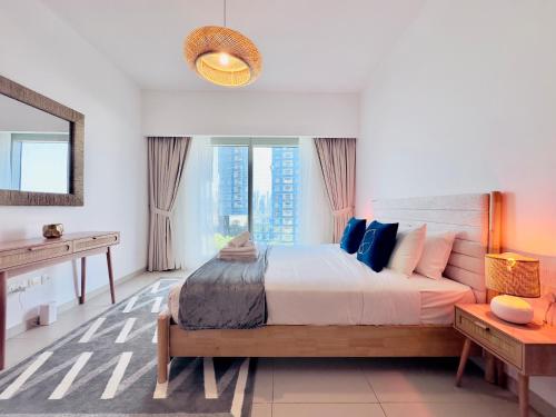 a bedroom with a large bed and a large window at Modern City Escape Gate Towers Al Reem in Abu Dhabi