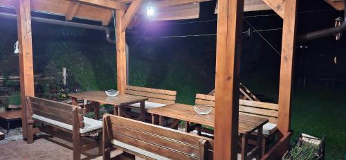a wooden table and benches on a patio at Vila Pohoda Javorníky s rozľahlým pozemkom in Makov