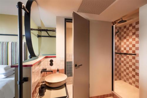 a bathroom with a toilet and a shower at Me and All Hotel Berlin East Side, by Hyatt - NEW OPENING in Berlin