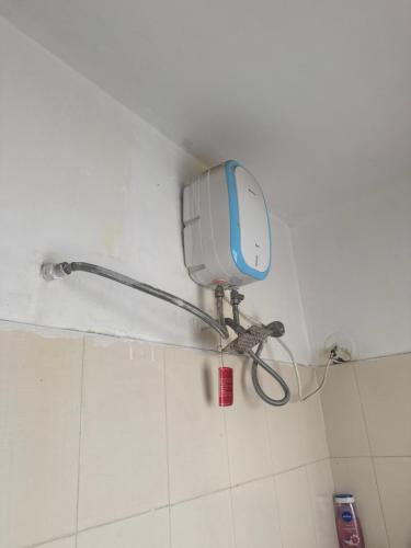 a shower on a wall in a bathroom at Nisarg Nirmitee Society in Pune