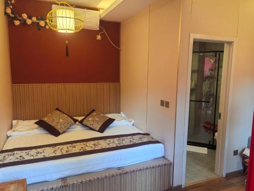 a bedroom with a bed and a chandelier at Rong Hotel - Beijing Nanluoguxiang Branch in Beijing
