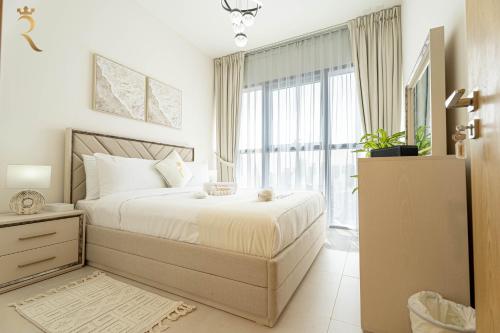 a bedroom with a bed and a large window at 2BR Luxe Haven - Chic Al Reem Escape in Abu Dhabi