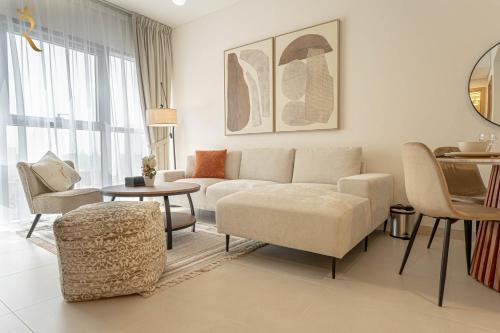 a living room with a couch and chairs and a table at 2BR Luxe Haven - Chic Al Reem Escape in Abu Dhabi