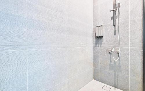 a bathroom with a shower with a glass door at Shire Hotel Seomyeon in Busan