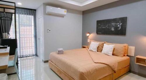 a bedroom with a large bed in a room at The Hub Hotel Surin in Surin