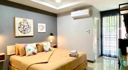 a bedroom with a large bed in a room at The Hub Hotel Surin in Surin
