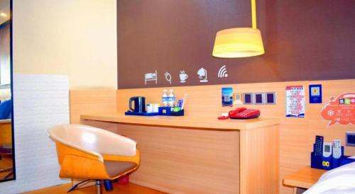 a room with a counter with a chair and a desk at IU Hotel Chengdu High-Tech Zone Longhu Times Street in Chengdu
