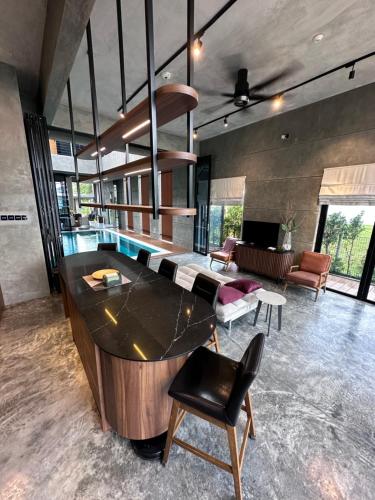 a large living room with a large island in the middle at Villa AZJA PD in Port Dickson