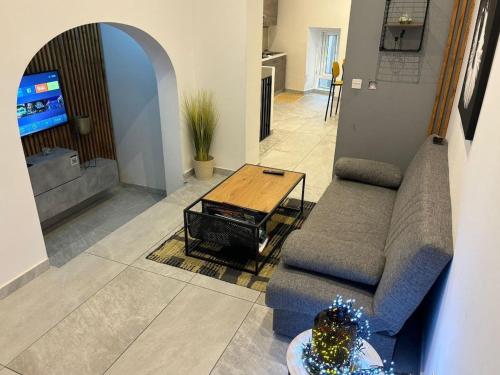 a living room with a couch and a table at Chic 2-BR Loft w and Yard in Pieta