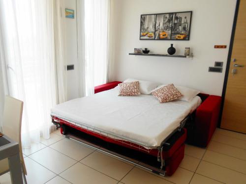 a bed with two pillows on it in a room at La trifula bianca apts. in Alba
