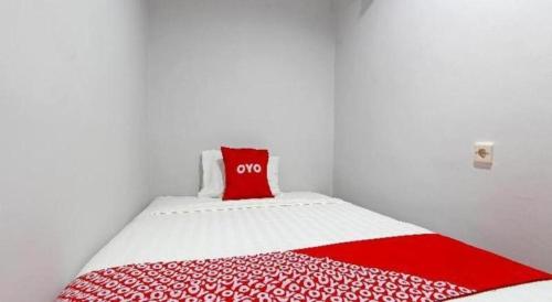 a small room with a red pillow on a bed at OYO 91531 Dreamstay 2 in Semarang