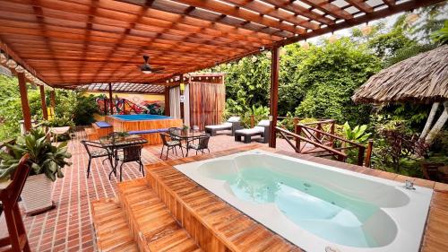 an outdoor pool with a hot tub on a patio at Ecohotel Yachay Dentro del Parque Tayrona Inside Tayrona Park in El Zaino